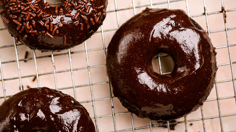 Donuts with chocolate glaze on wire rack