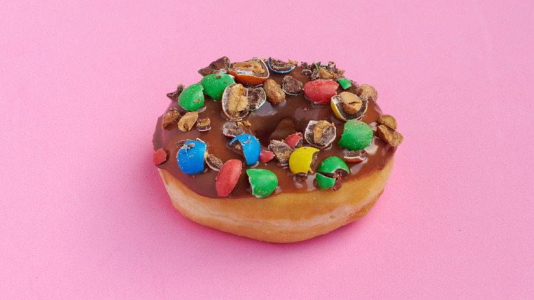 Peanut M&Ms on chocolate frosted donut