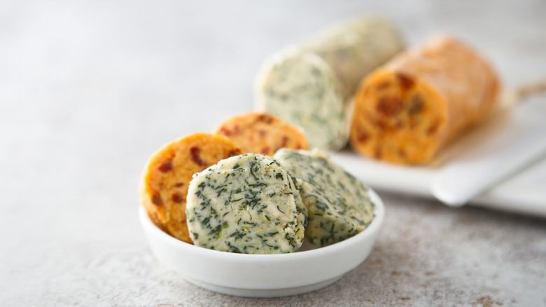 Discs of compound butter on white plate