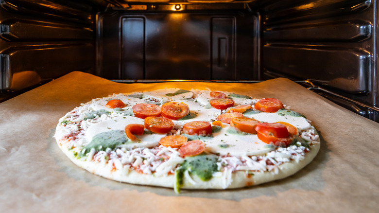 Frozen pizza on a baking sheet in the oven