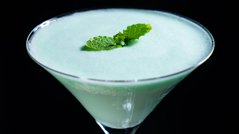 Pale green grasshopper cocktail garnished with two mint leaves