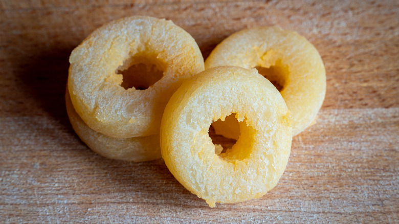 Four donut rounds of tvaruzky cheese on a wooden table