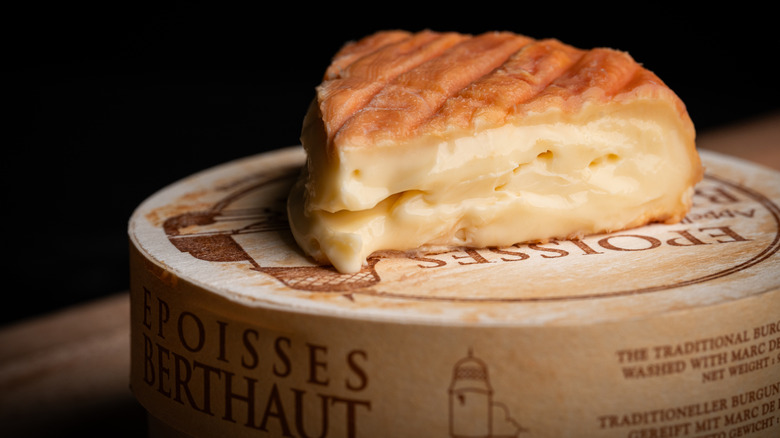 A ripe wedge of Époisses on a container