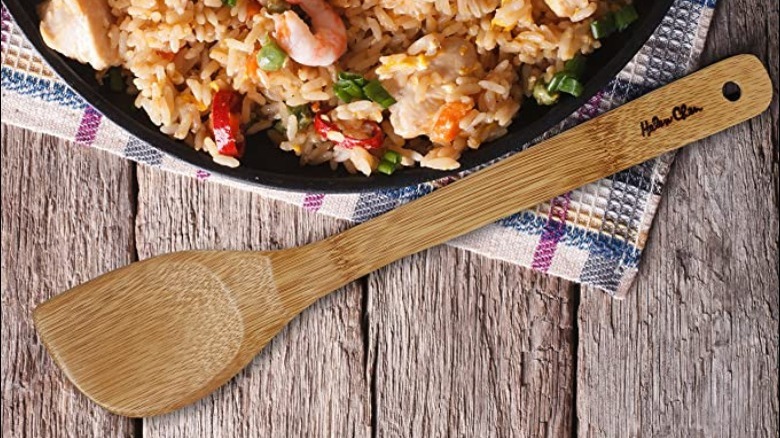 Wood spatula beside rice dish