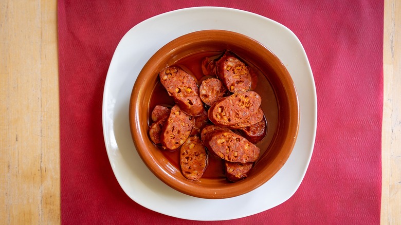Earthenware bowl of chorizo a la sidra