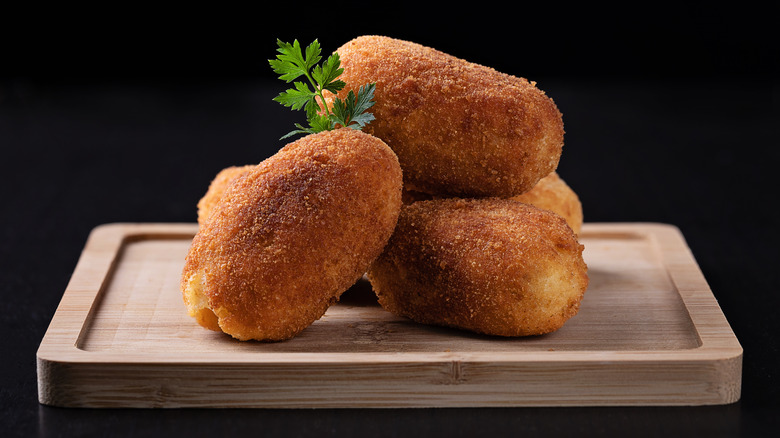 Croquetas on a wooden cutting board