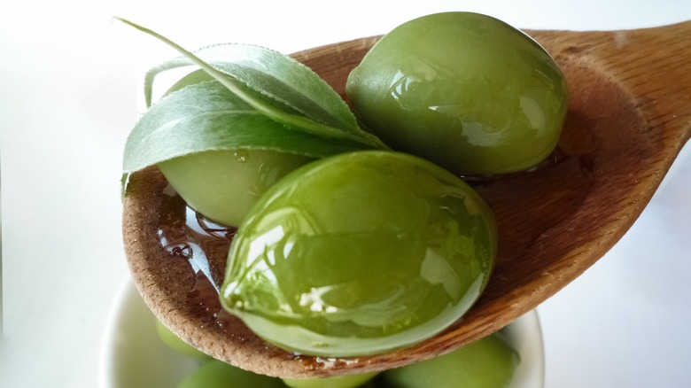 Wooden spoon filled with Gordal olives