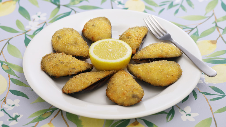 White plate of tigres with half a lemon