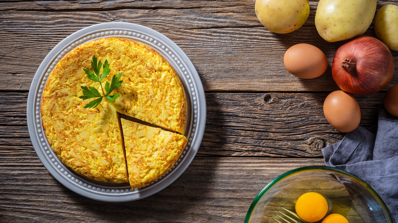 Tortilla de patatas on a plate with one slice