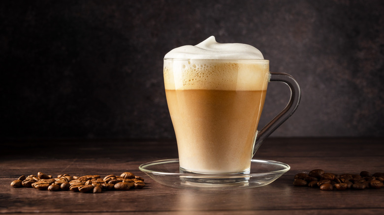 an espresso latte with foamy milk in a glass cup