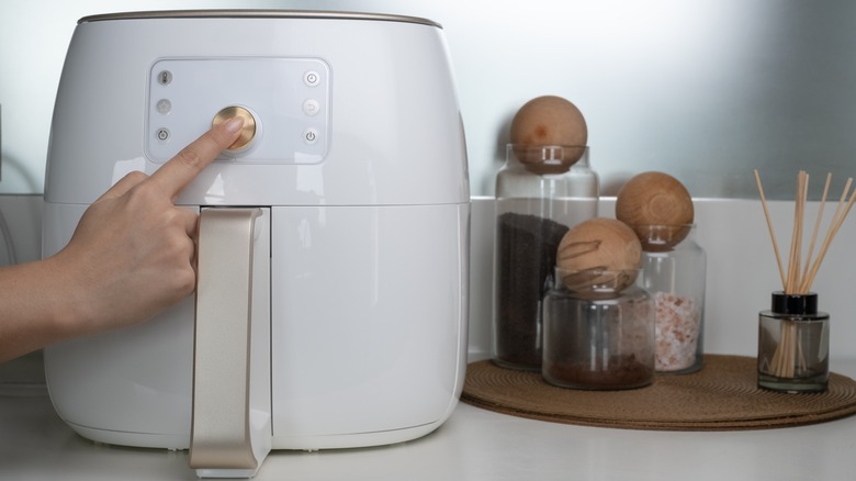 pressing button on air fryer