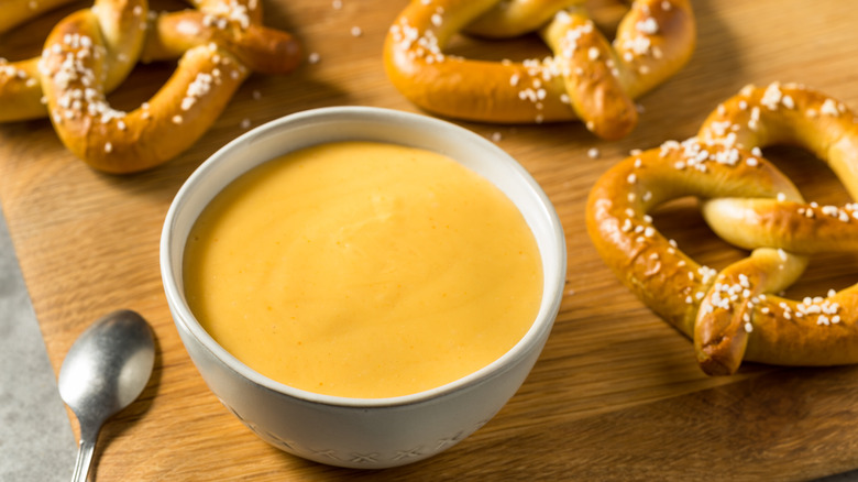 Kentucky beer cheese dip in a crock served with pretzels