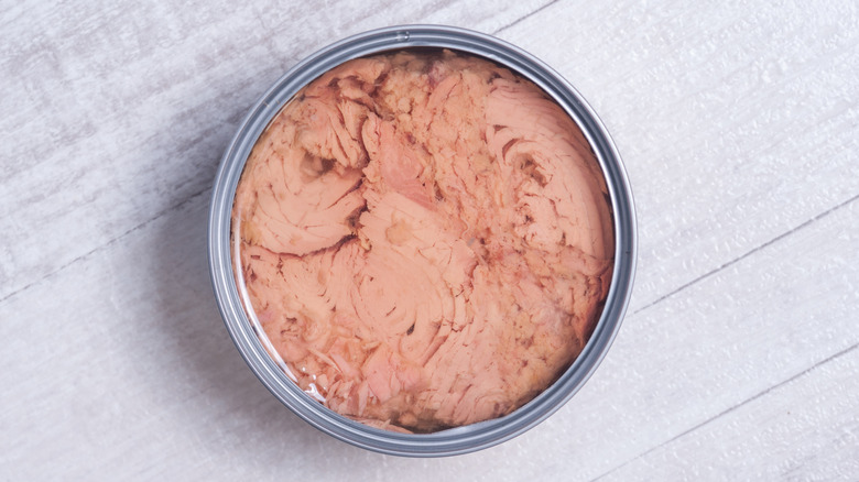 Canned tuna on wooden table