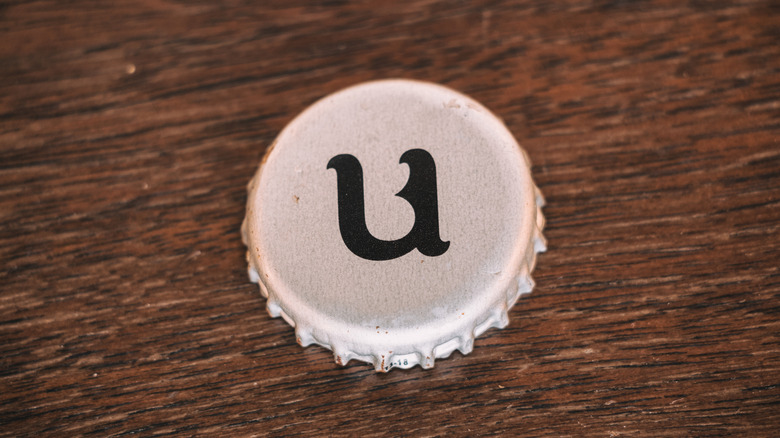 A close-up of the distinctive lower case "u" on a Unibroue bottle cap