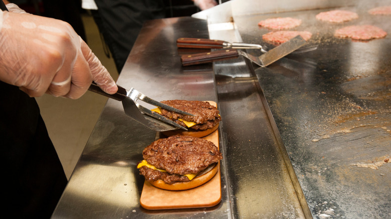 Cook preparing burgers at Steak 'n Shake
