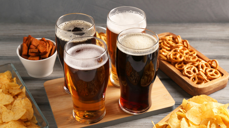 Different beer styles with various snacks.