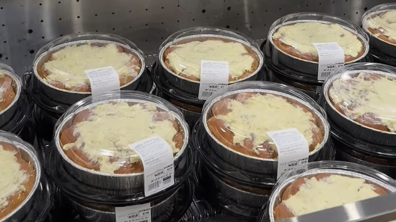 A display cooler filled with round trays of garlic parmesan butter dinner rolls
