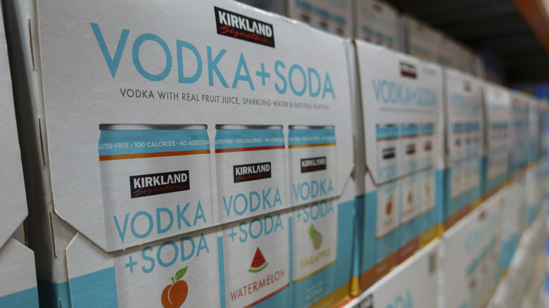 Cases of Kirkland Signature vodka and soda lined up on a shelf