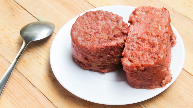 Canned corned beef on white plate by spoon