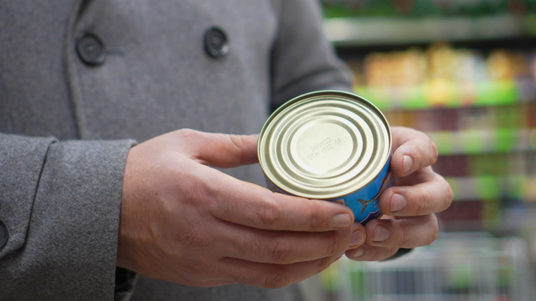 Person holding can