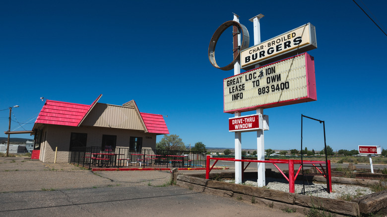 A closed and abandoned Dairy Queen, with all signage removed except "Great Location Lease To Own" on the marquee