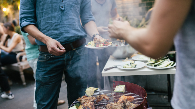 People by grill at cookout