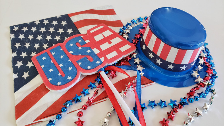 Fourth of July-themed hat, sign, and napkins