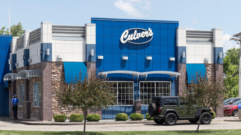 Exterior of Culver's restaurant with car driving by on sunny day