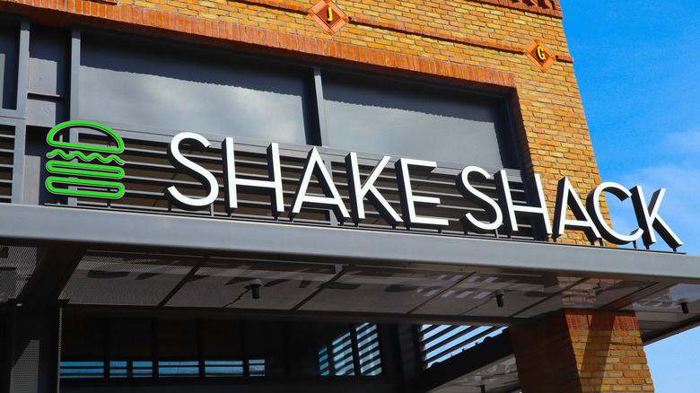 Shake Shack sign outside restaurant on sunny day