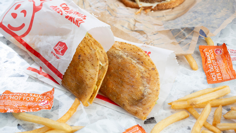 Close-up of Jack in the Box tacos with sauce and fries