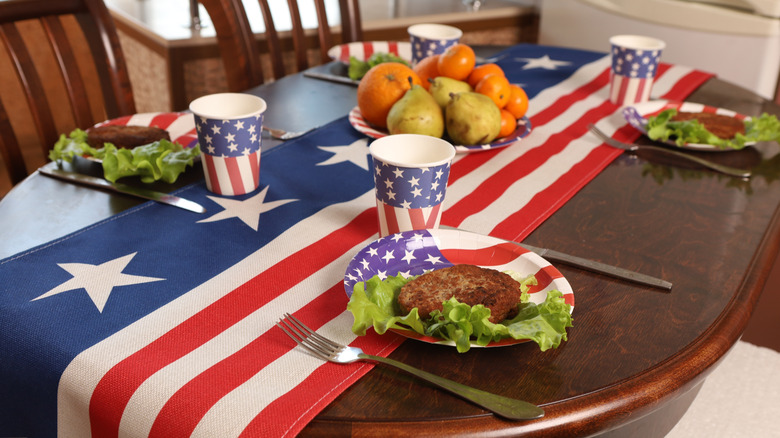 Dining room table with American flag-themed runner and place settings