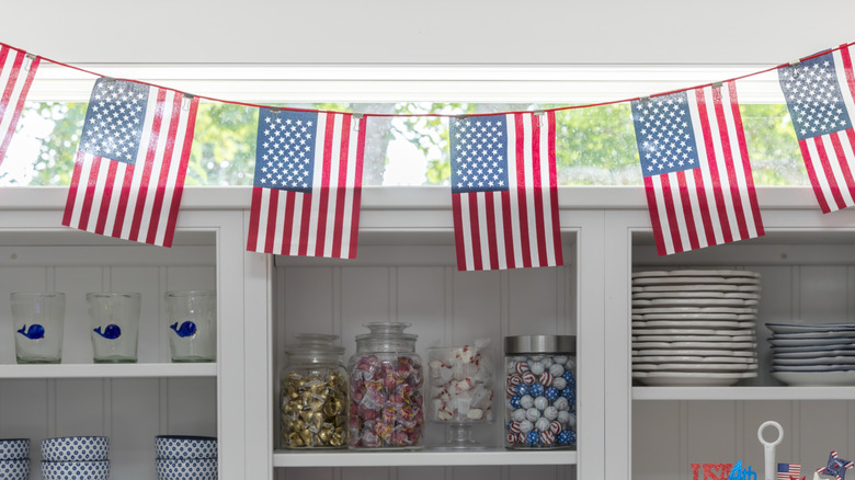 American flag banner hanging along white open shelving