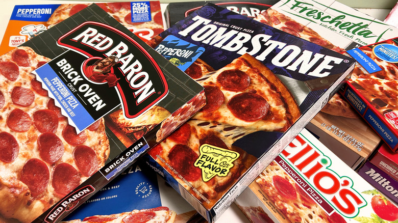 Several frozen pizza boxes piled together