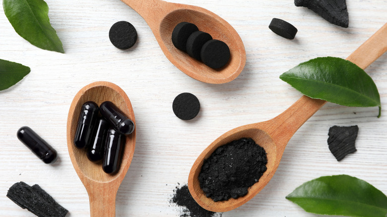 Activated charcoal tablets in a spoon
