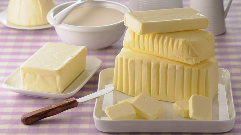 Various forms of butter on a picnic table