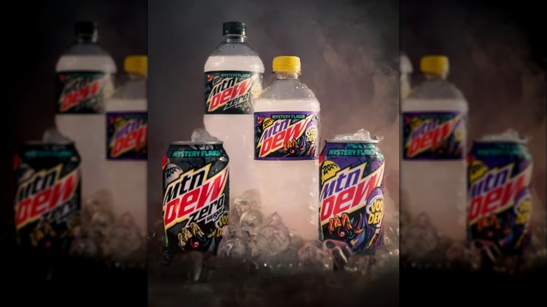 Bottles and cans of 2024's Mountain Dew VooDEW, in both full sugar and zero sugar varieties. The labels are mostly purple and black.