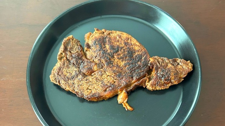 Outback Steakhouse ribeye steak on a black plate