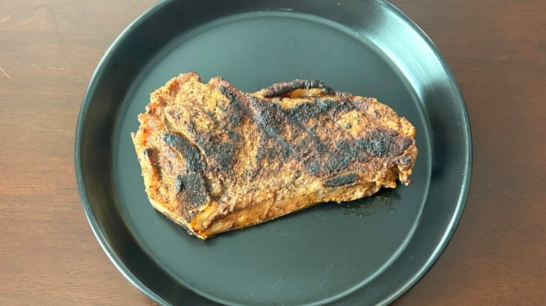 Outback Steakhouse New York strip steak on a black plate
