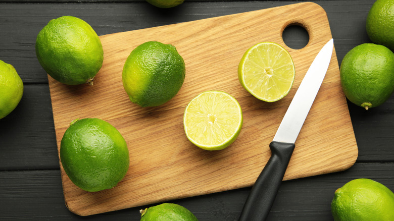Sliced limes on a wood cutting board