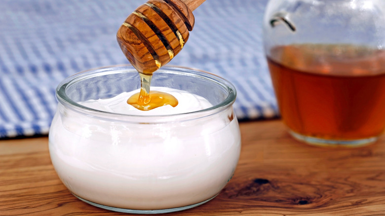 Honey over Greek yogurt in bowl