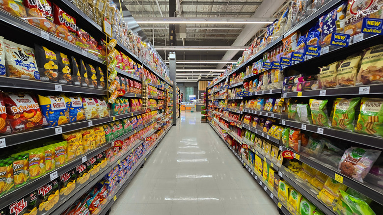 Fully stocked snack aisle in grocery store