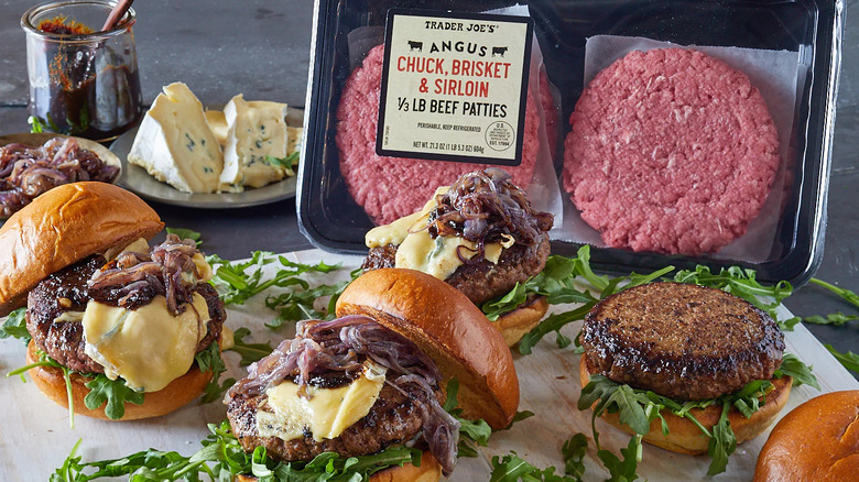 a platter of cooked burgers with a package of Trader Joe's Angus Chuck Brisket and Sirloin Beef Patties behind it.