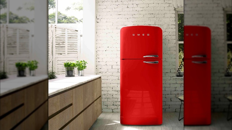 A bright red Smeg refrigerator in an otherwise neutral-color kitchen