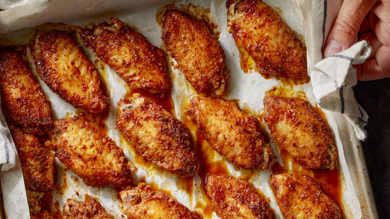 Cooked chicken wings on baking tray