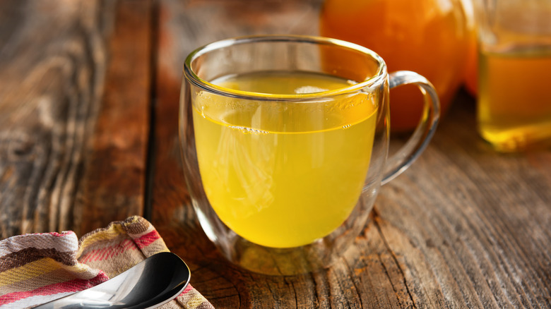 Raw honey and apple cider vinegar on an old wooden table top.