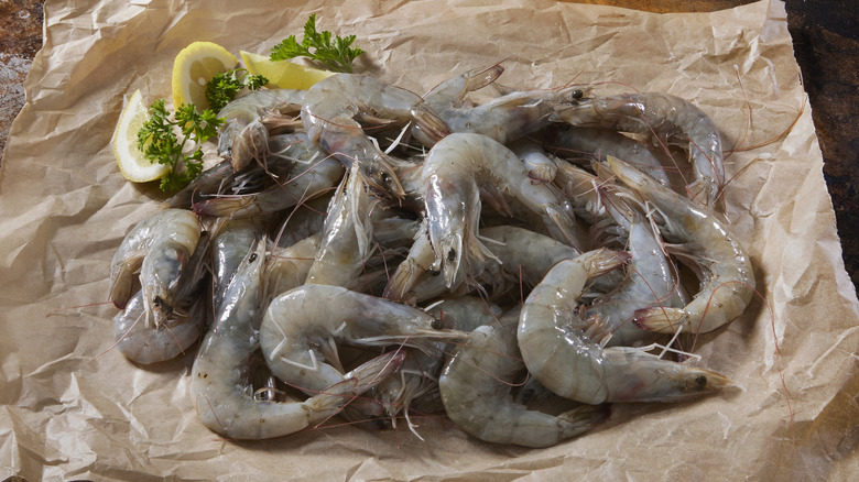 Raw shrimp on butcher paper.