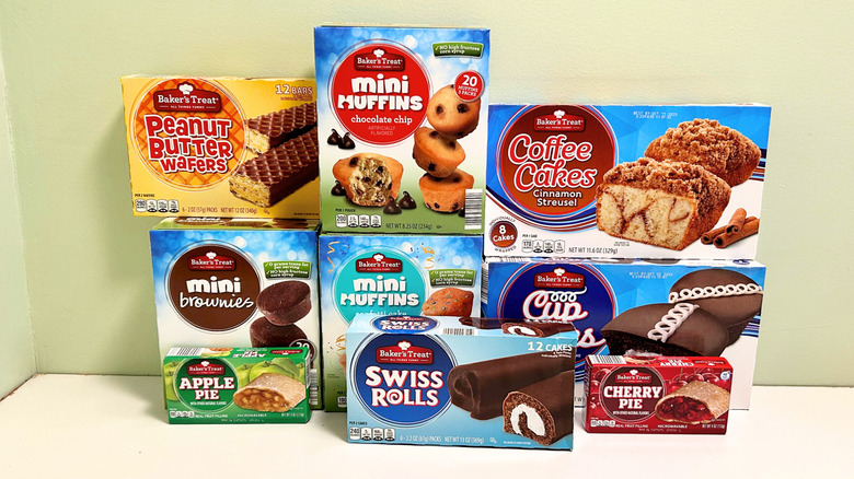 Several Aldi pre-packaged snack options stacked together against a green and white background