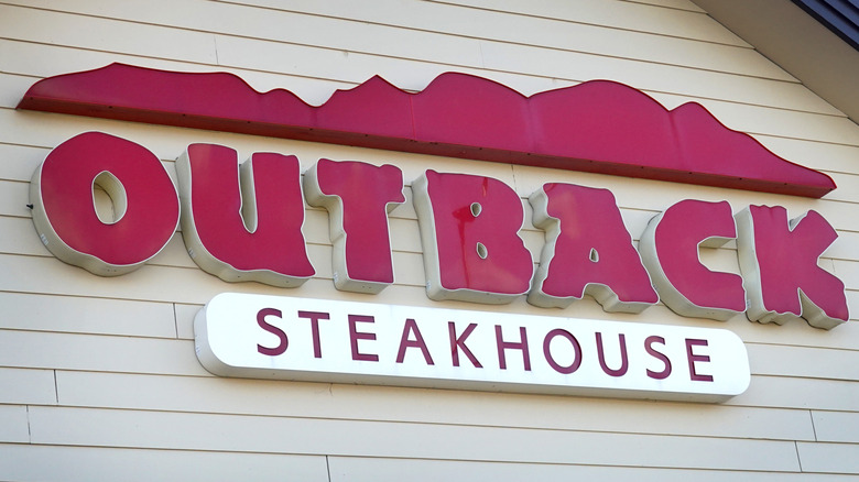 Outback Steakhouse sign from the outside of a restaurant.