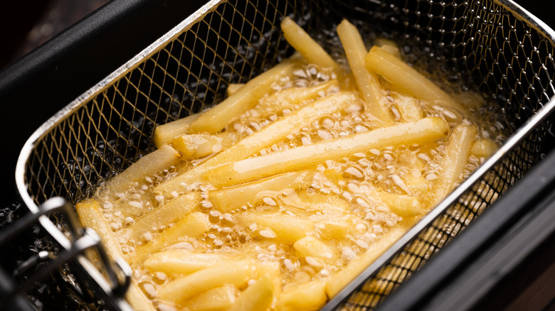 French fries being cooked in oil