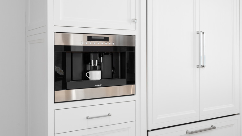 White cabenetry with built-in coffee maker by Wolf